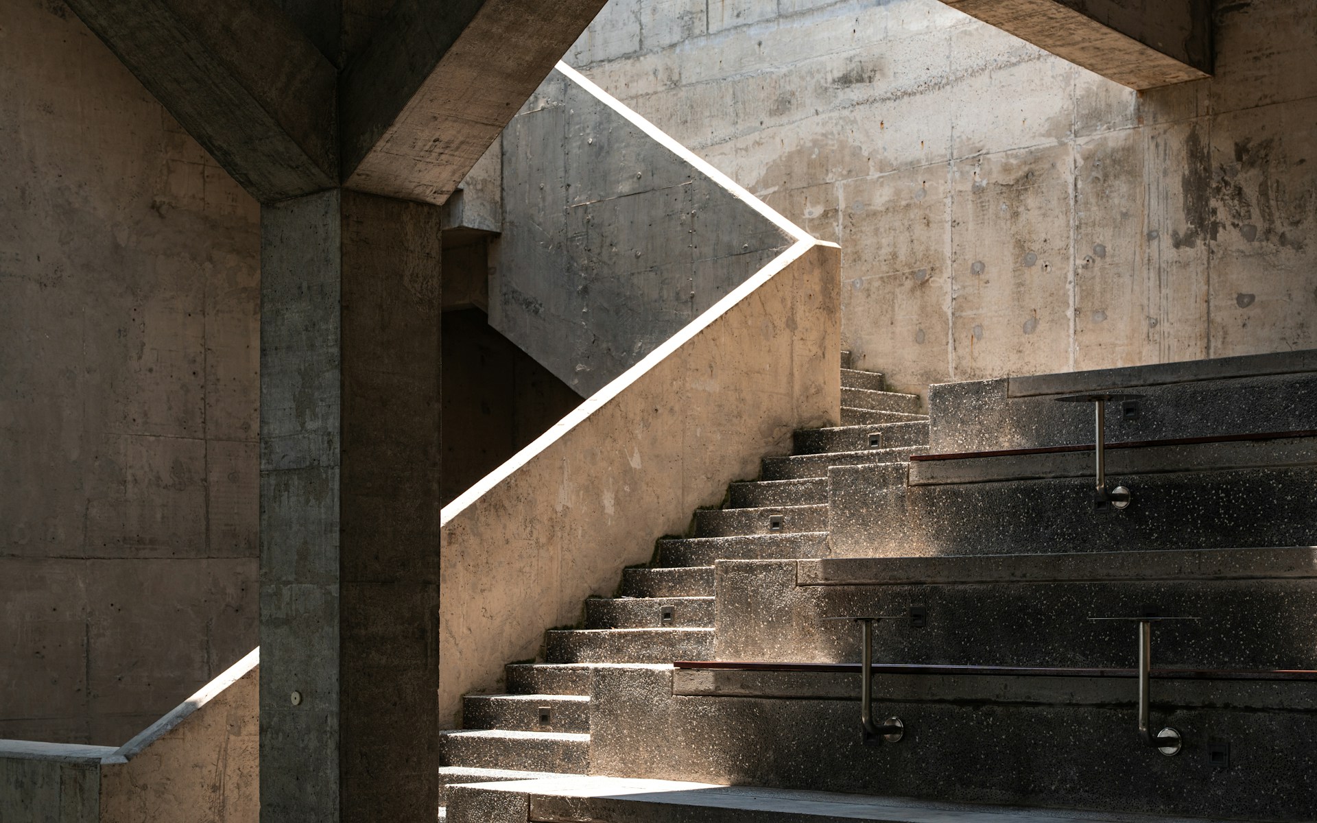 Concrete architectural staircase representing the structured infrastructure local broadcasters need to scale into national advertising